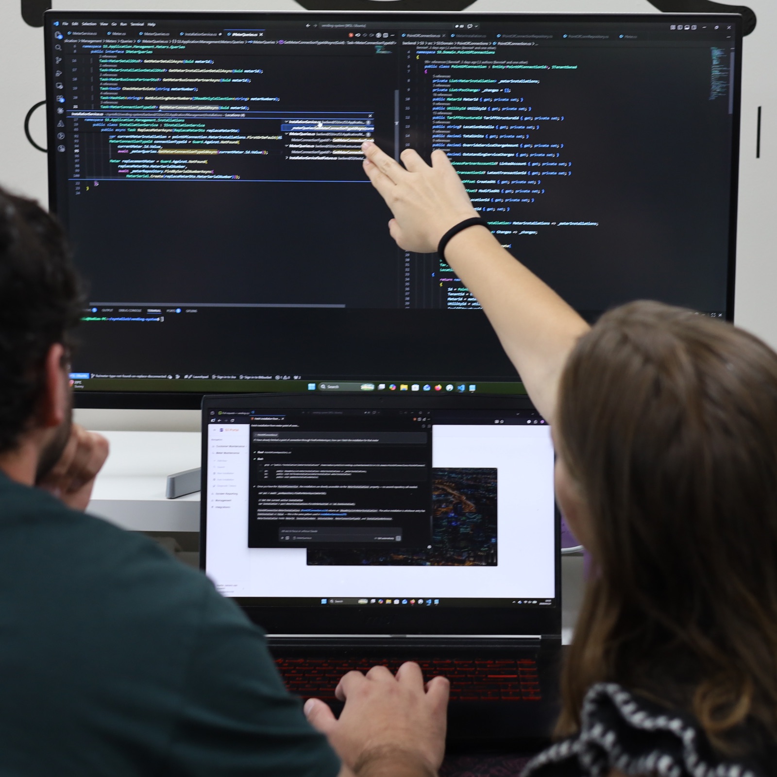 Software engineers reviewing code together